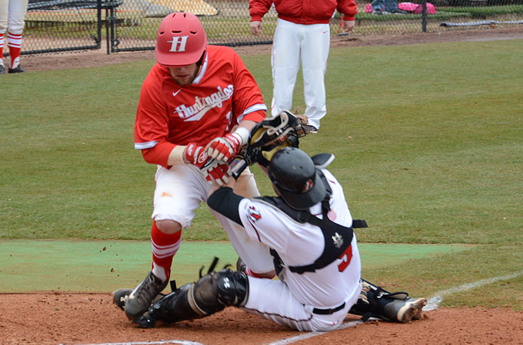 Catcher Chad Pigg tags out Huntingdon's Jordan Freeman in the first game of Saturday' doubleheader.